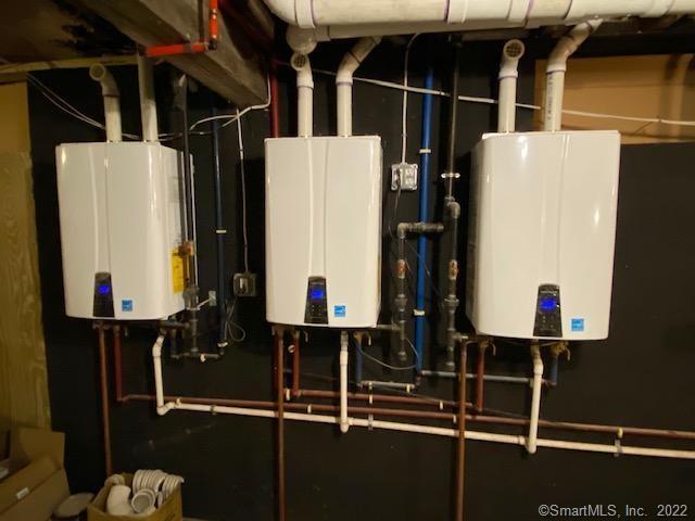 utility room featuring tankless water heater