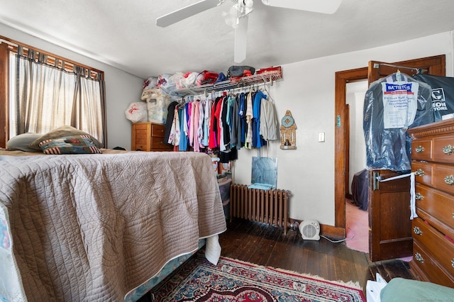 bedroom featuring ceiling fan, radiator heating unit, a closet, a textured ceiling, and wood-type flooring