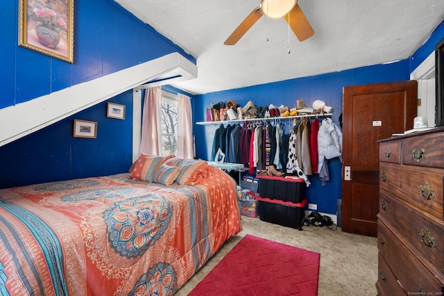 bedroom with a textured ceiling, a ceiling fan, and carpet