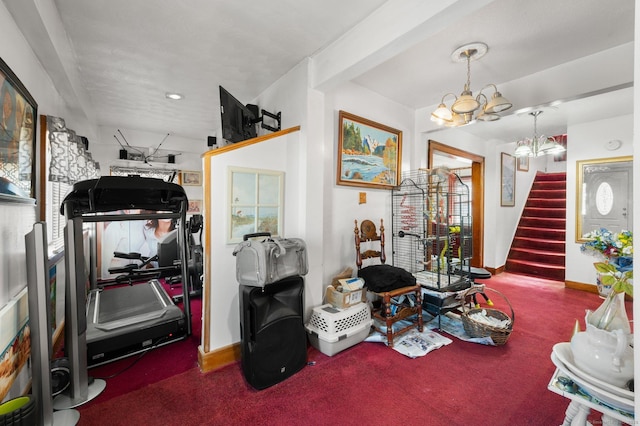 interior space featuring a chandelier, carpet, and baseboards