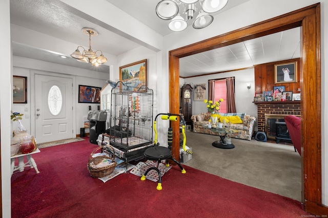 interior space with a notable chandelier and a fireplace