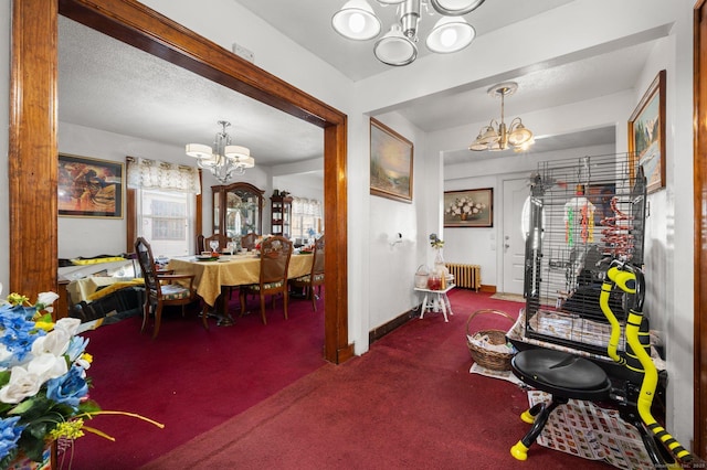 dining area with baseboards, carpet floors, an inviting chandelier, radiator heating unit, and a textured ceiling