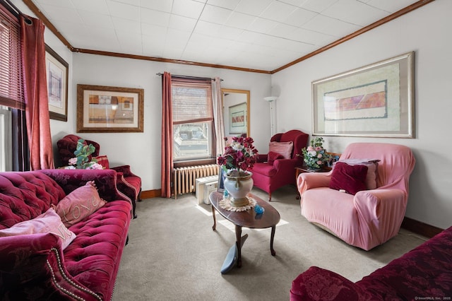 living room with baseboards, carpet floors, ornamental molding, and radiator heating unit