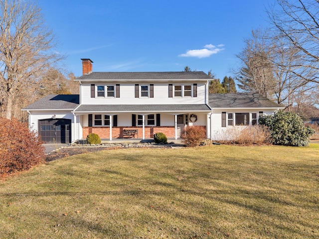 traditional-style home with brick siding, a front yard, covered porch, a chimney, and a garage