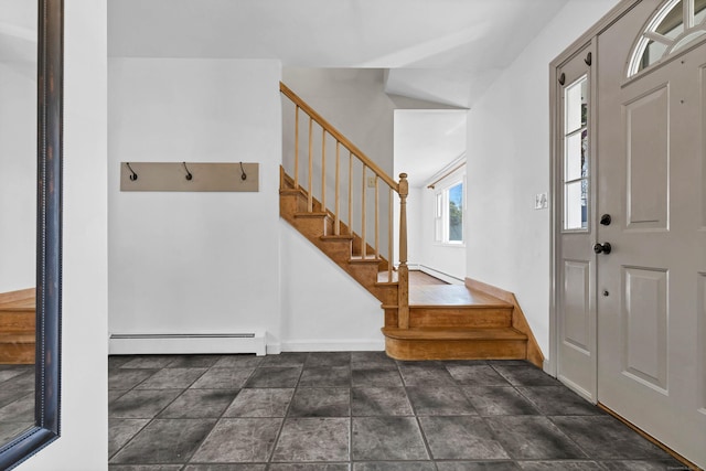 entryway featuring a baseboard radiator, baseboards, and stairway