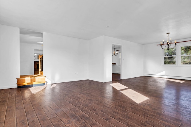 unfurnished living room featuring a baseboard heating unit, baseboards, a notable chandelier, and hardwood / wood-style flooring