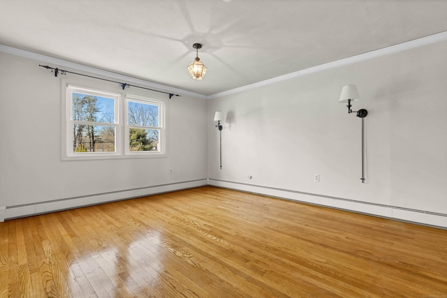 spare room featuring crown molding, light wood-style floors, and a baseboard radiator