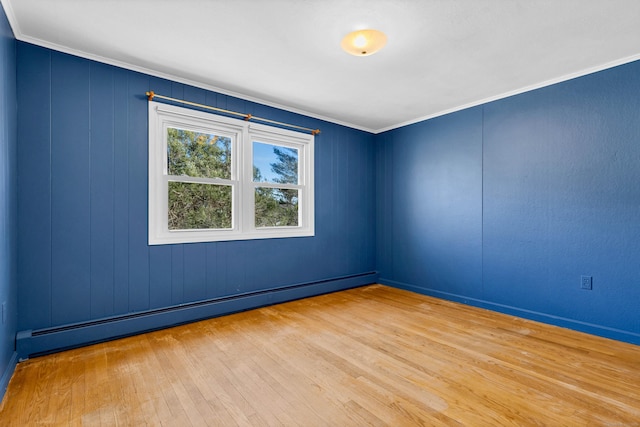 unfurnished room featuring hardwood / wood-style floors, ornamental molding, and a baseboard radiator