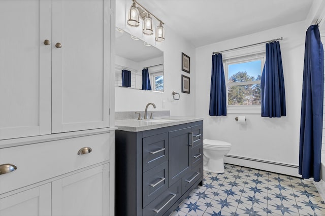 bathroom with tile patterned floors, toilet, vanity, and a baseboard radiator