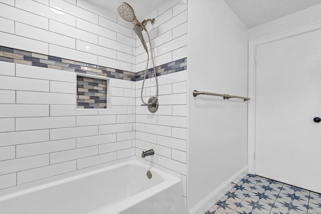 bathroom with tile patterned floors, baseboards, and shower / washtub combination