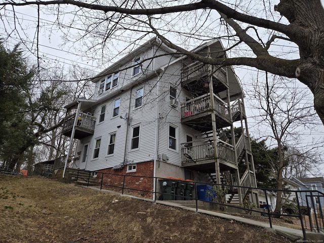 exterior space with a balcony and fence