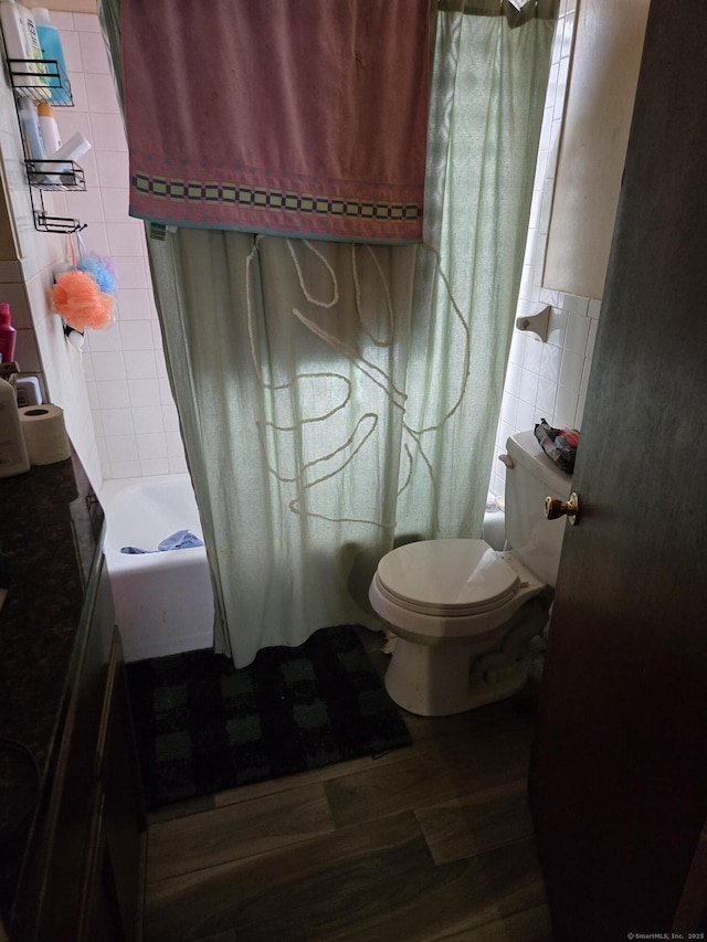 full bathroom featuring a shower with curtain, toilet, tile walls, and wood finished floors