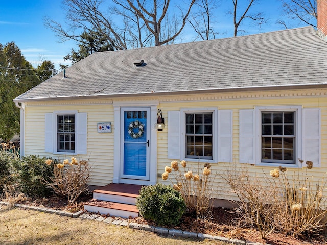 view of front of home with a shingled roof