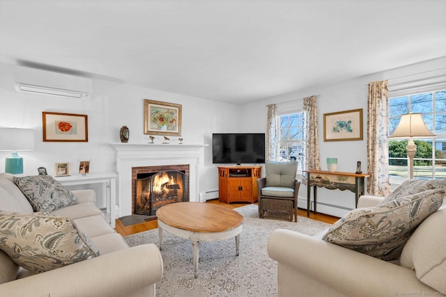 living room featuring a baseboard heating unit, a brick fireplace, wood finished floors, and a wall mounted air conditioner