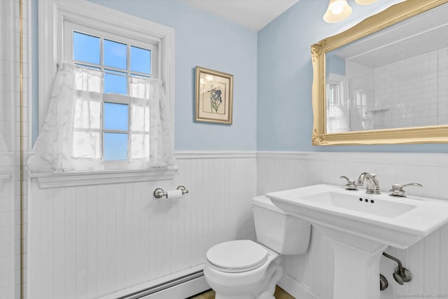 bathroom featuring a wainscoted wall, toilet, a baseboard heating unit, and walk in shower