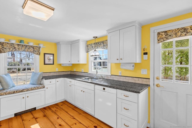 kitchen featuring a sink, dishwasher, and white cabinets