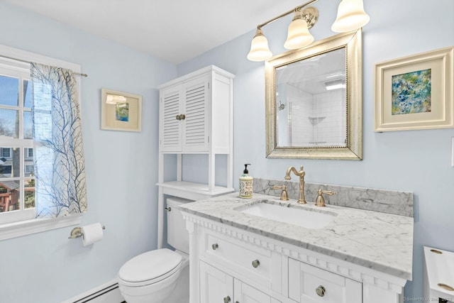 full bathroom featuring vanity, toilet, and baseboard heating