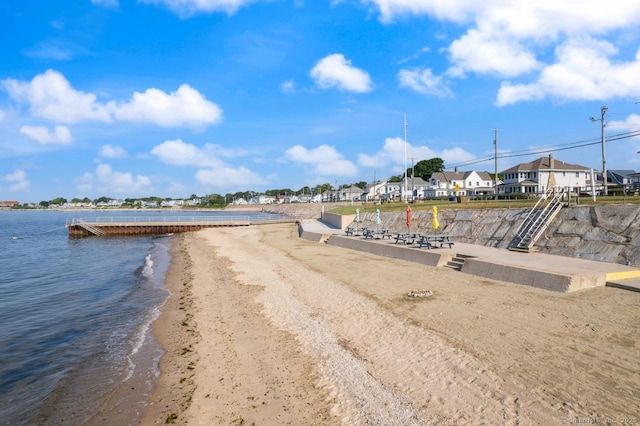 view of dock featuring a water view and a residential view