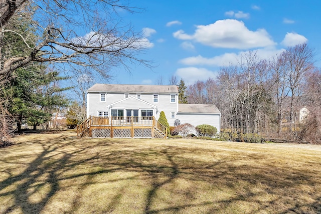 back of house with stairs, a deck, and a yard