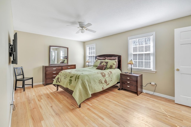 bedroom with baseboards, light wood-type flooring, and ceiling fan