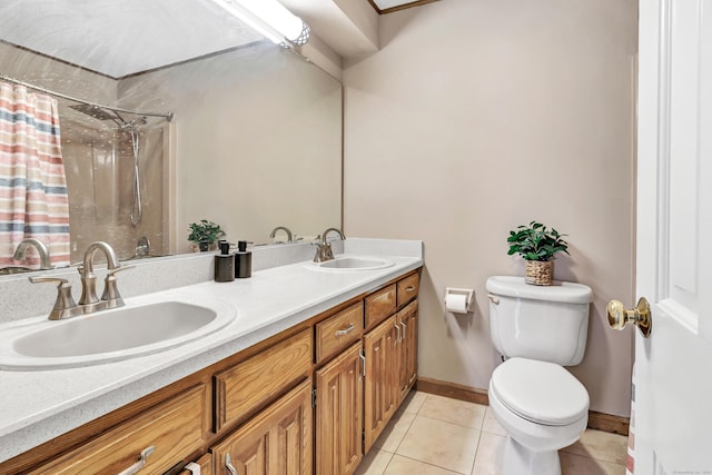 bathroom featuring a sink, toilet, a shower with shower curtain, and tile patterned flooring