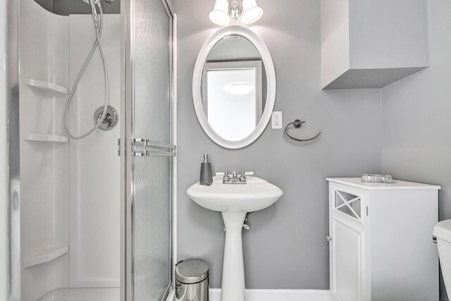 bathroom featuring toilet and a stall shower