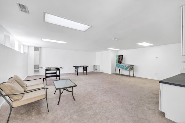 sitting room with light carpet, visible vents, and baseboards