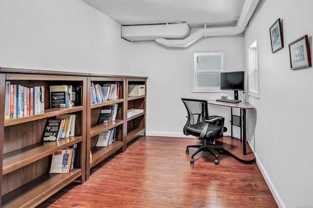 office space featuring baseboards and wood finished floors