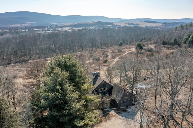 drone / aerial view with a mountain view and a wooded view