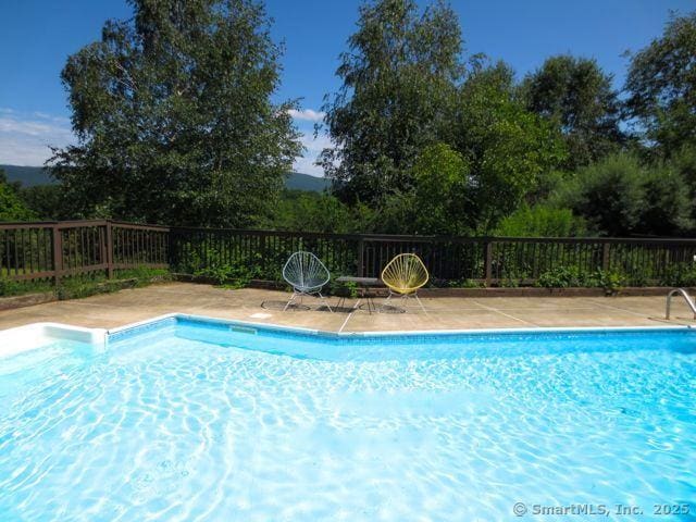 view of swimming pool featuring a fenced in pool and fence