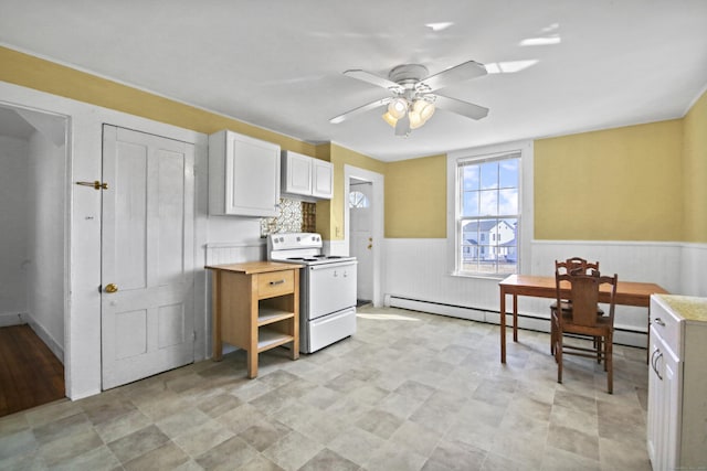 kitchen with white cabinetry, white range with electric stovetop, wainscoting, light countertops, and ceiling fan