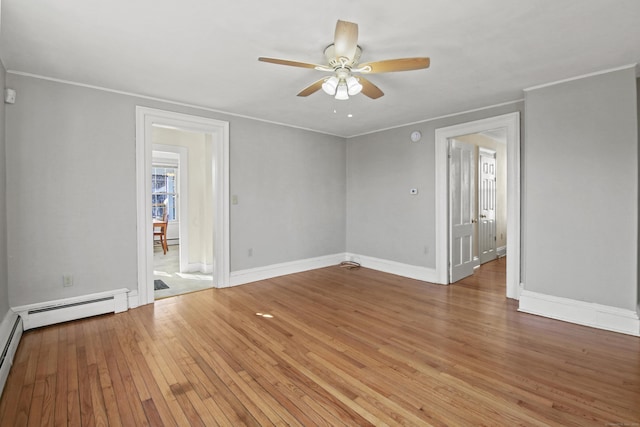 empty room featuring crown molding, baseboards, ceiling fan, light wood-type flooring, and baseboard heating