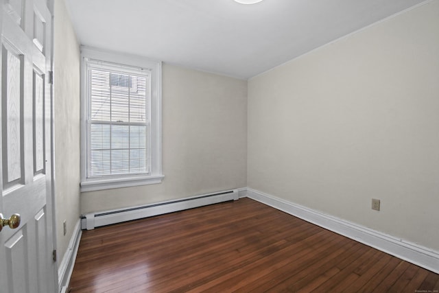 empty room with dark wood finished floors, baseboards, and a baseboard radiator