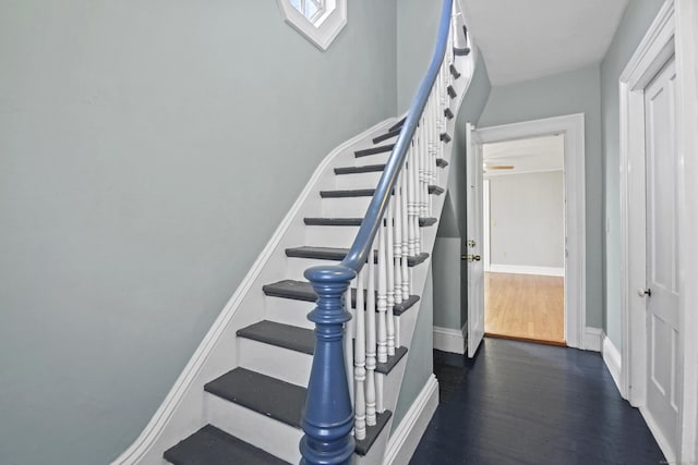 stairs featuring baseboards and wood finished floors