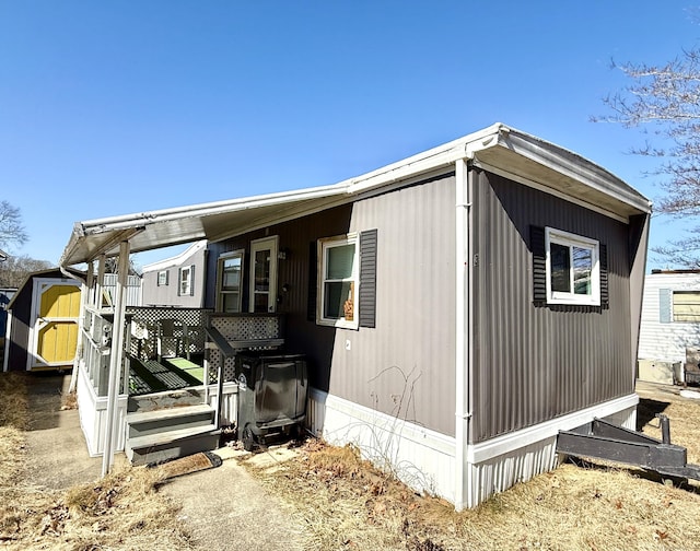 view of side of property featuring an outbuilding