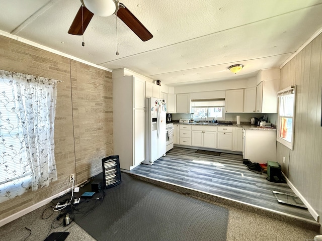 kitchen featuring white cabinetry, ceiling fan, white appliances, a textured ceiling, and a sink