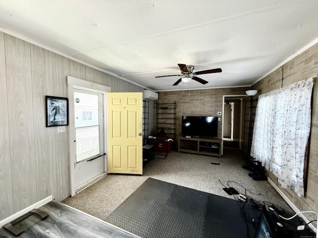 unfurnished living room featuring carpet flooring, a textured ceiling, an AC wall unit, and a ceiling fan