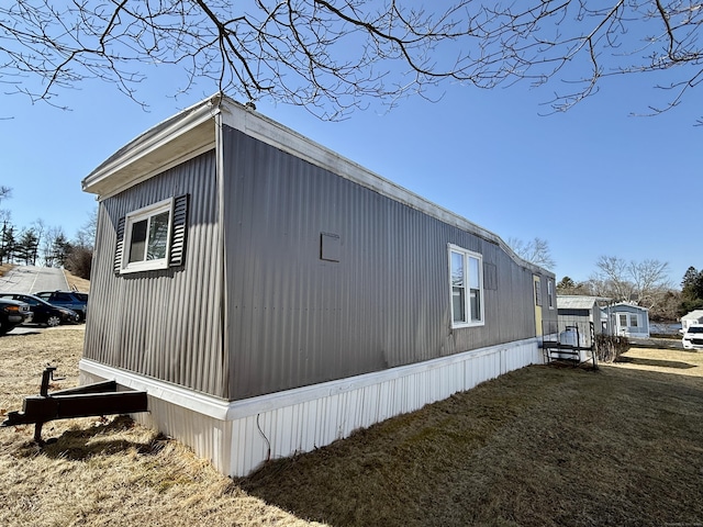 view of side of home featuring a yard