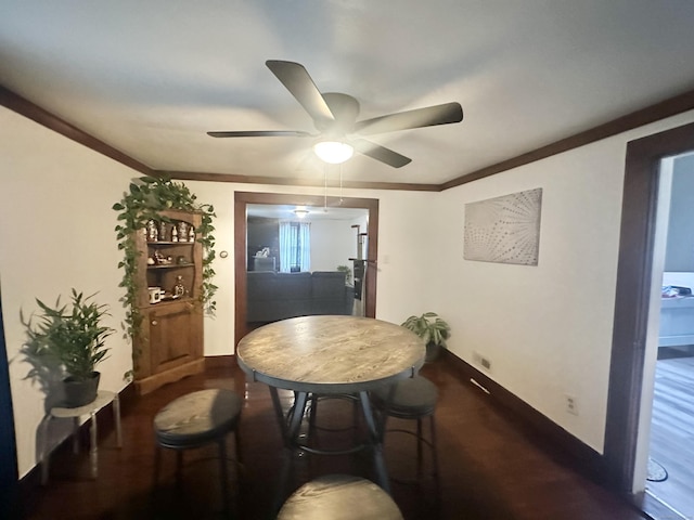 dining area featuring baseboards, ceiling fan, and crown molding