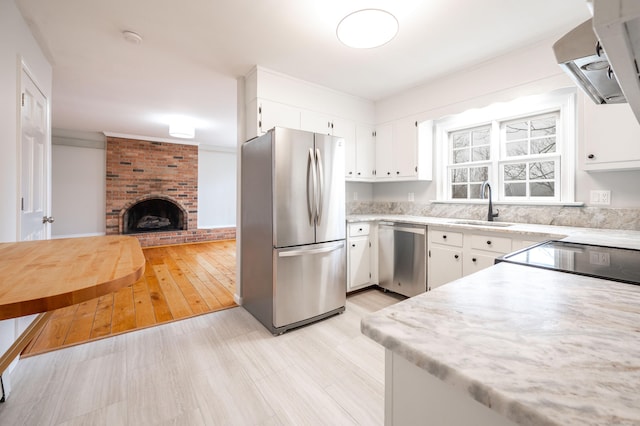 2 Old Middle Rd, Brookfield, CT 06804 - kitchen with stainless steel appliances, a sink, light countertops, wall chimney exhaust hood, and white cabinets