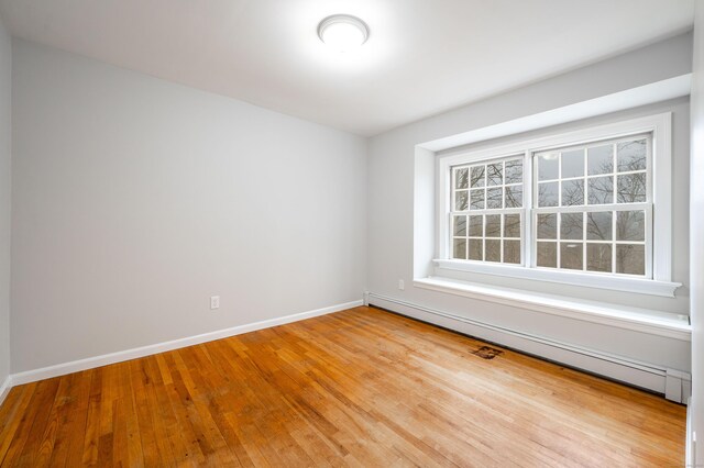 2 Old Middle Rd, Brookfield, CT 06804 - empty room featuring a baseboard heating unit, healthy amount of natural light, wood finished floors, and baseboards
