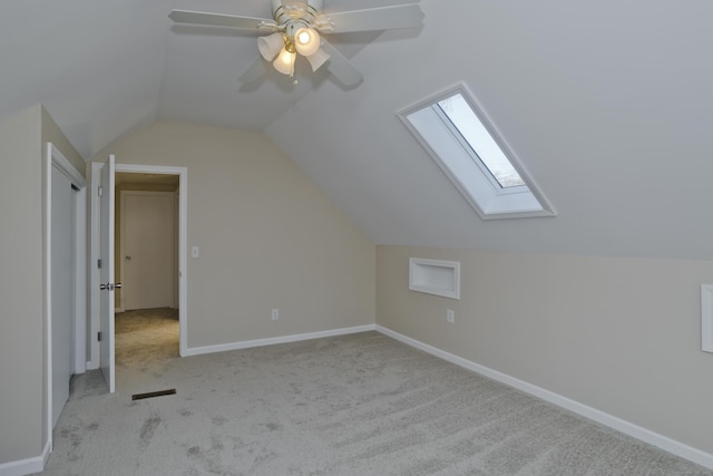 bonus room with vaulted ceiling with skylight, carpet, visible vents, and baseboards