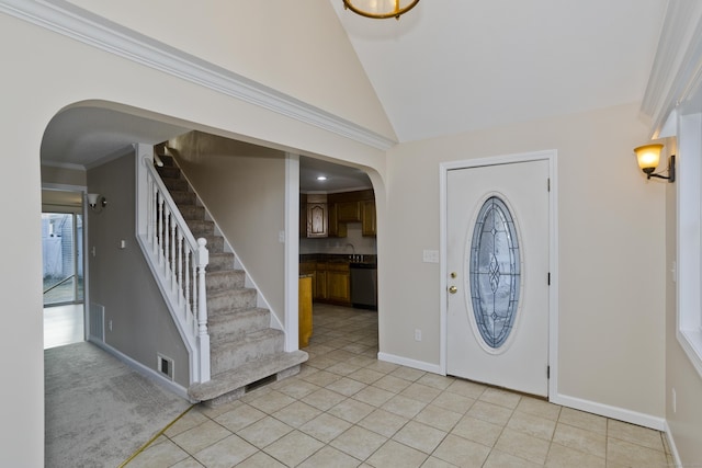 foyer featuring visible vents, baseboards, stairway, ornamental molding, and arched walkways