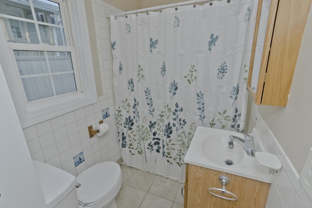 bathroom featuring vanity, tile patterned flooring, curtained shower, tile walls, and toilet