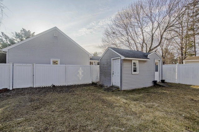 view of yard with an outdoor structure and a fenced backyard