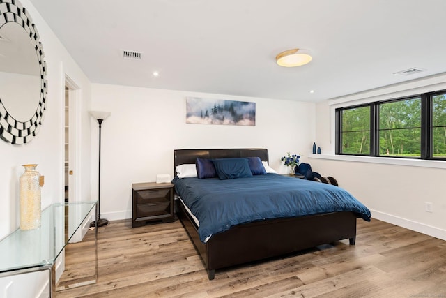 bedroom with visible vents, recessed lighting, baseboards, and wood finished floors