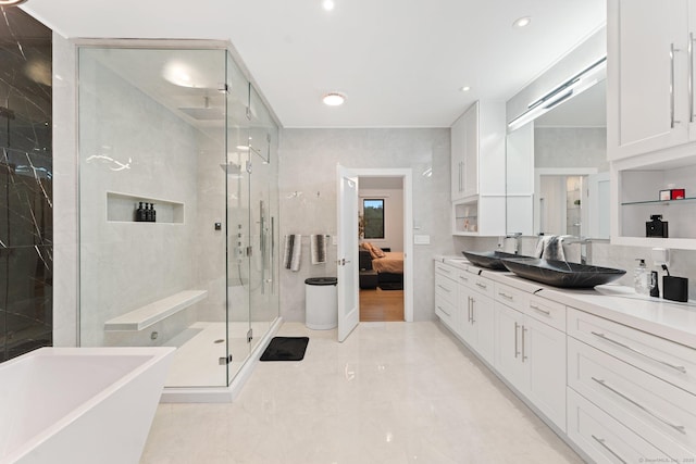 ensuite bathroom with a shower stall, recessed lighting, ensuite bathroom, a soaking tub, and vanity