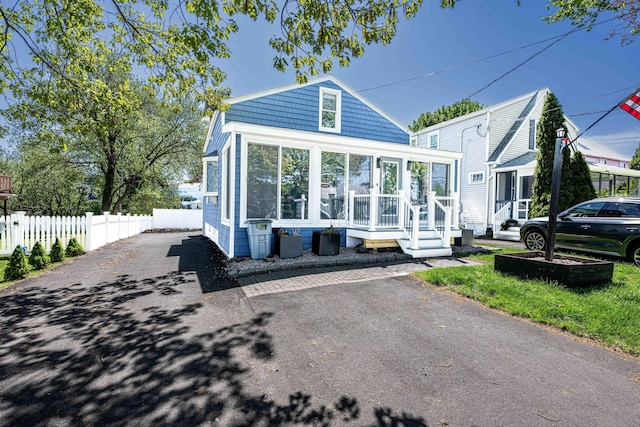45 S St, East Haven, CT 06512 - view of front of house with fence, a sunroom, and driveway