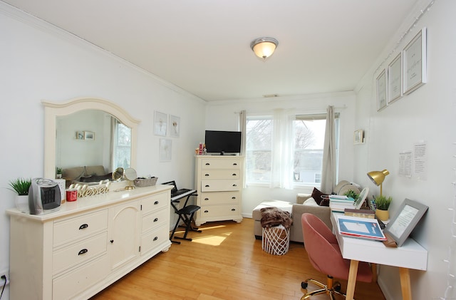 bedroom with crown molding and light wood-style floors