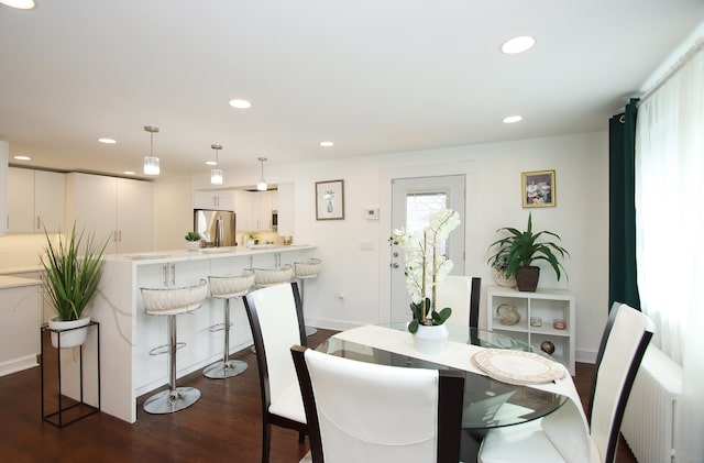 dining area with dark wood finished floors, radiator, recessed lighting, and baseboards